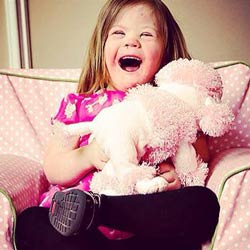 Young girl with pink dog sits in a comfy chair