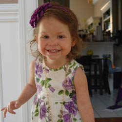 Young girl smiles in floral dress