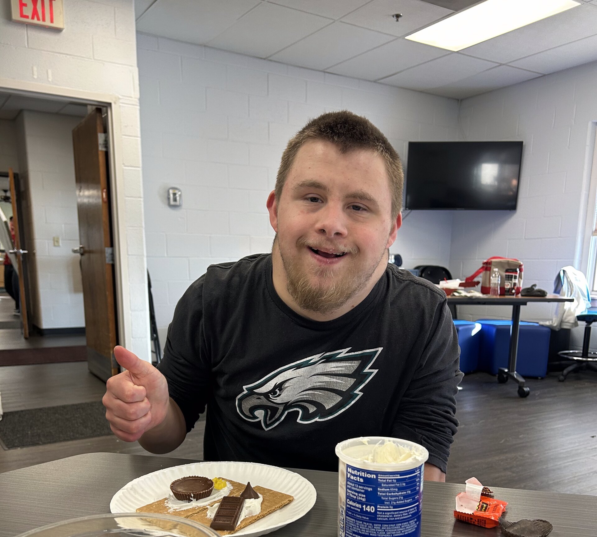 CLS Participant having fun during a gingerbread house making activity