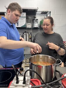 An Excentia day program participant preparing food during a cooking activity.