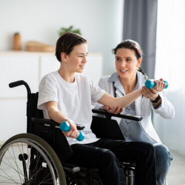 Boy Lifitng Weights In Wheelchair Pt