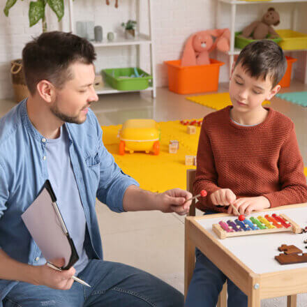 Man Working With Boy Playing Music